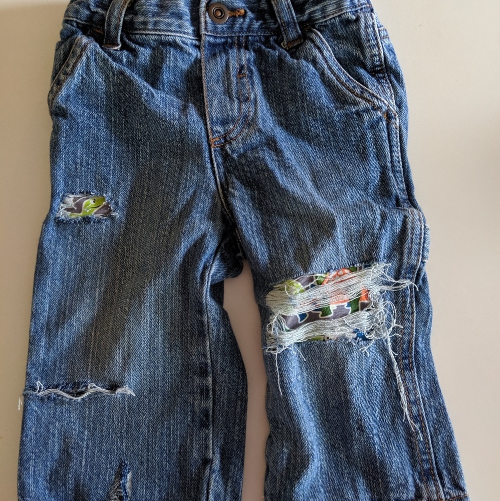 Cherokee infant 12-18 distressed dino fabric jeans